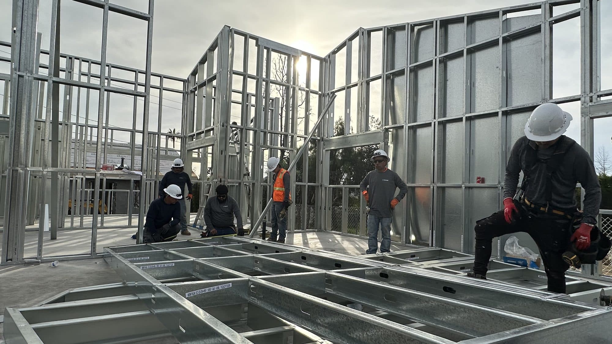 The crew working inside the steel frame