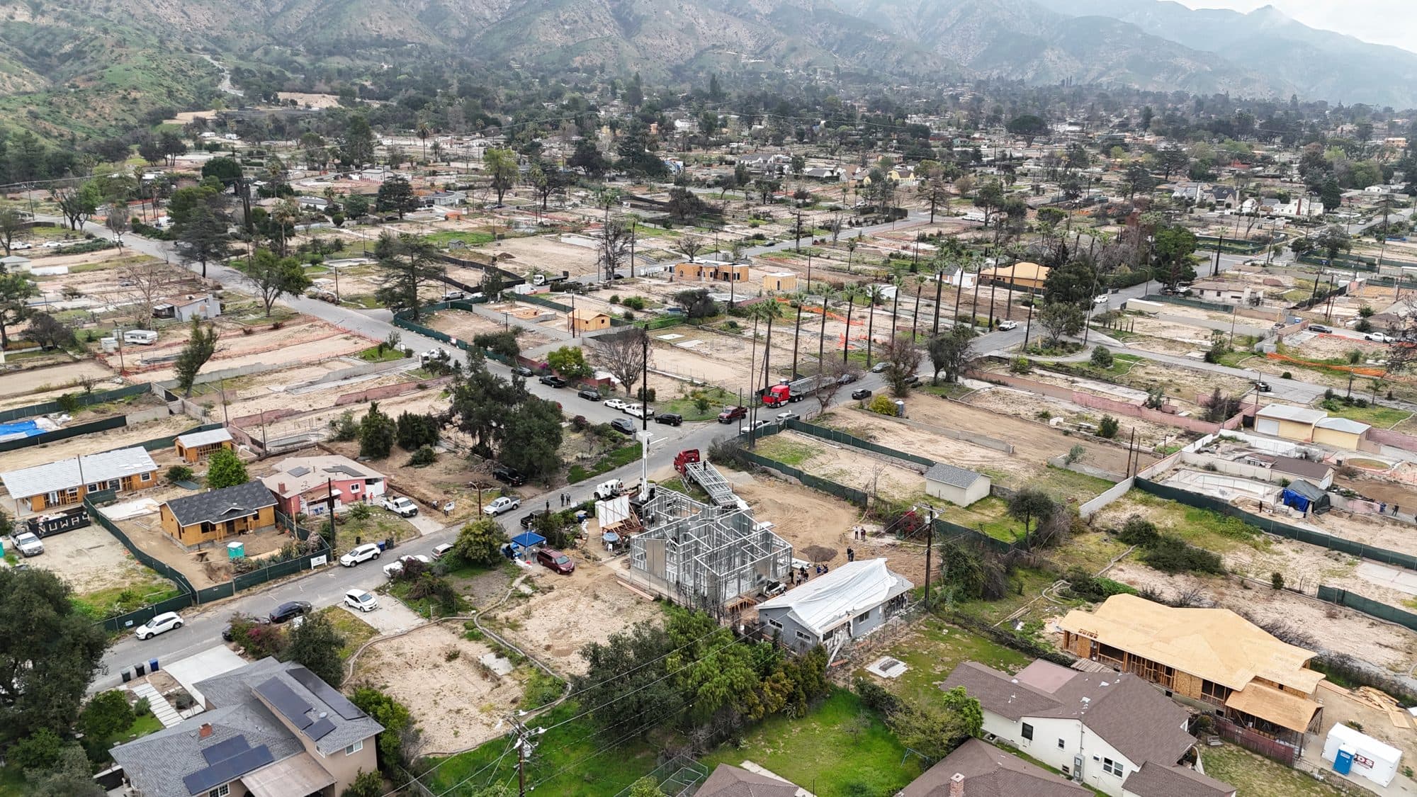 Aerial of the 480 W Palm steel rebuild rising amid the cleared Altadena burn zone