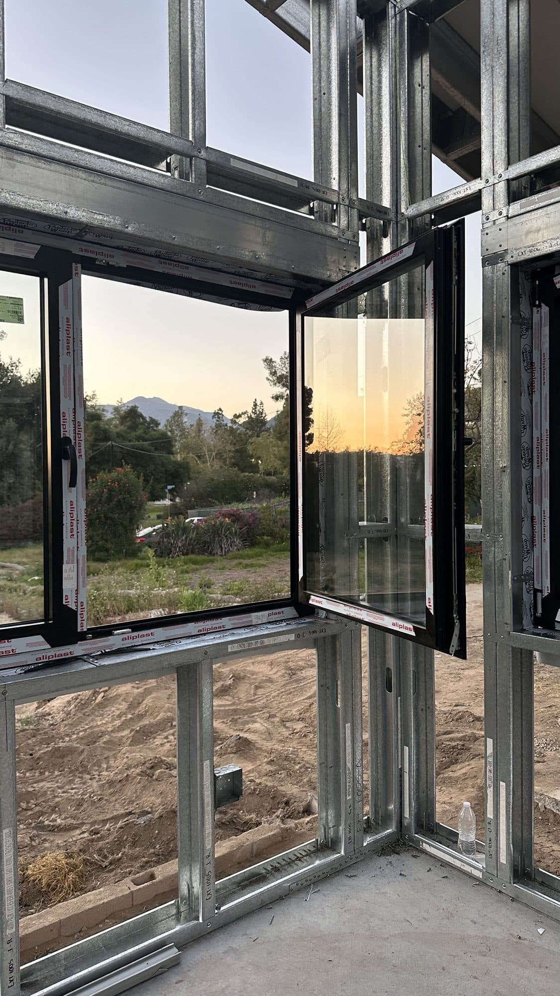 Black-framed windows set in the finished steel frame