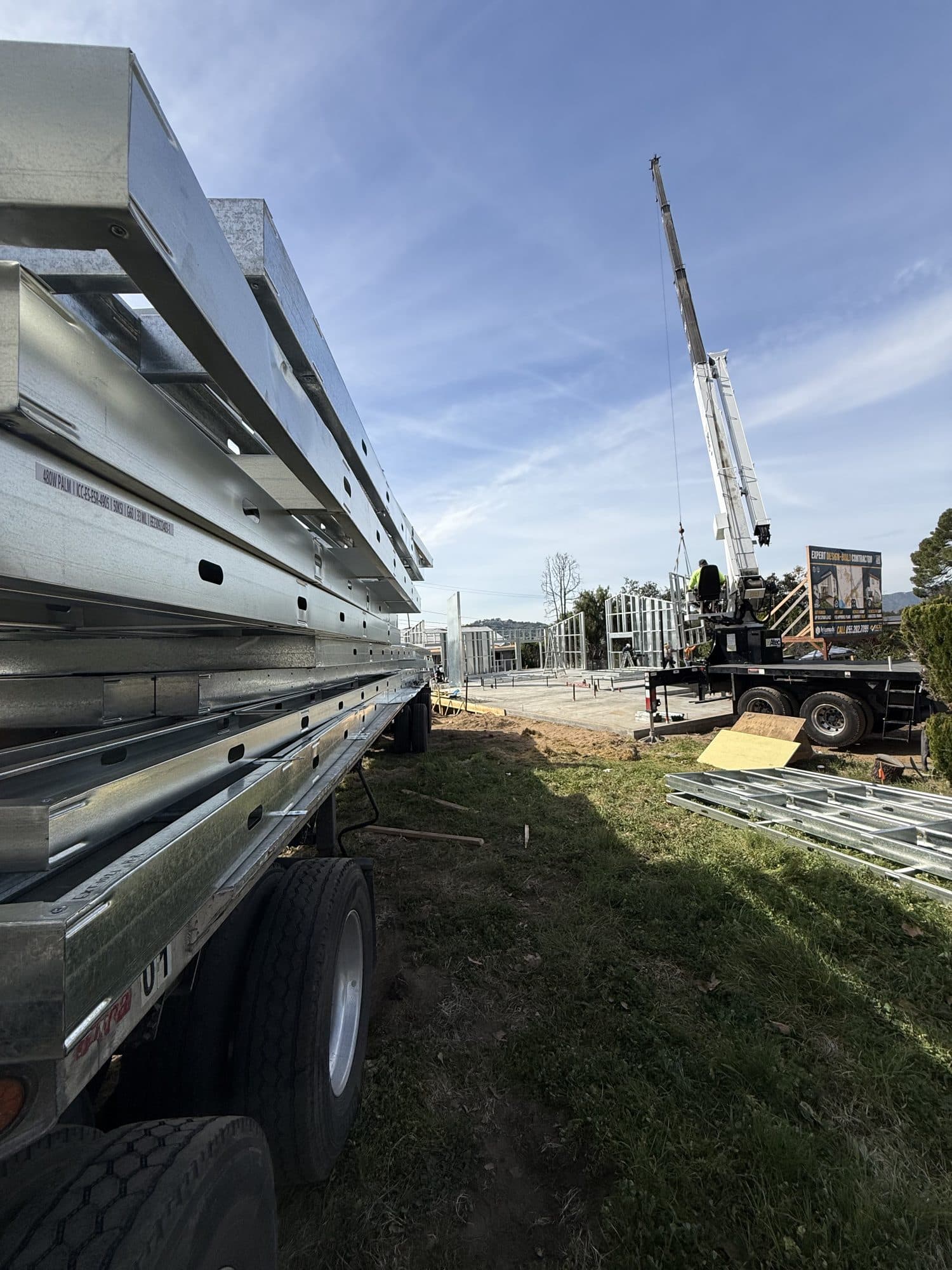 Factory-built light-gauge steel wall panels delivered to site on a flatbed
