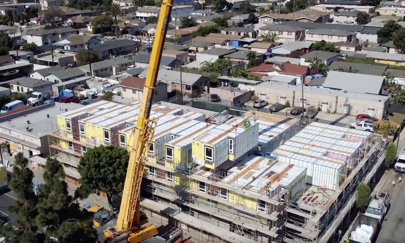Volumetric light-gauge steel modules being crane-set into a building